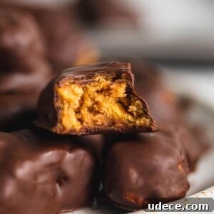 Homemade Butterfinger Candy Recipe Without Candy Corn 10 A plate of homemade butterfinger candy with one sitting on top with a bite out of it so you can see the crunchy texture inside.
