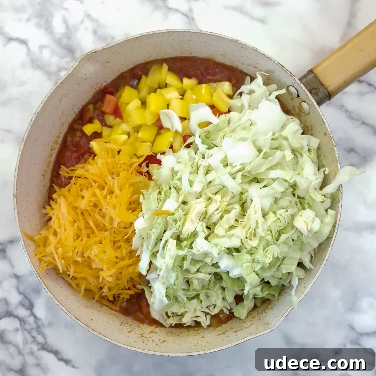 Chakalaka Recipe: Authentic South African Spicy Vegetable Relish 8 Step 4, raw cabbage, carrots and peppers added to the tomatoes and onions.