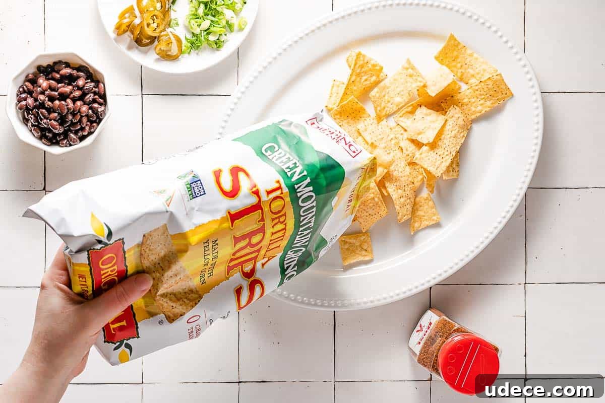Spicy Queso Chicken Nachos Recipe for Game Night 6 chips poured from bag onto platter