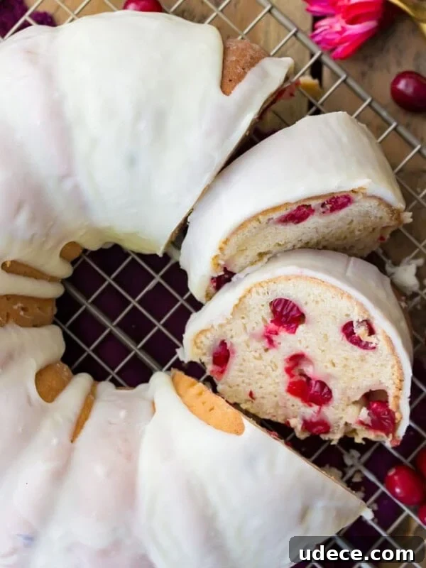 Gingerbread Layer Cake Recipe with Spiced Cream Cheese Frosting 14 Overhead image of sliced, iced cranberry bundt cake