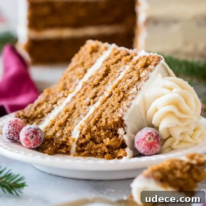 Gingerbread Layer Cake Recipe with Spiced Cream Cheese Frosting 9 Slice of gingerbread layer cake topped with cream cheese frosting and sugared cranberries.