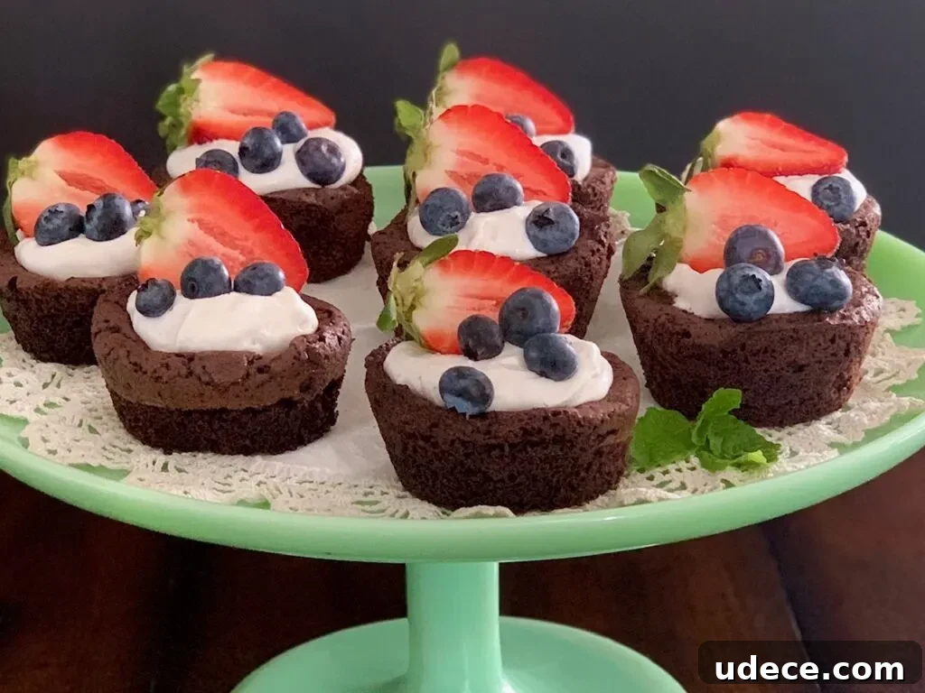 Mini Homemade Brownie Bites Recipe for Decadent Snackable Treats 6 A plate of homemade brownie bites with whipped topping and fruit.