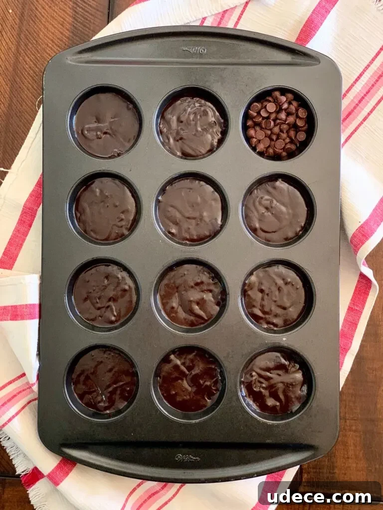 Mini Homemade Brownie Bites Recipe for Decadent Snackable Treats 4 A muffin pan filled with brownie batter.