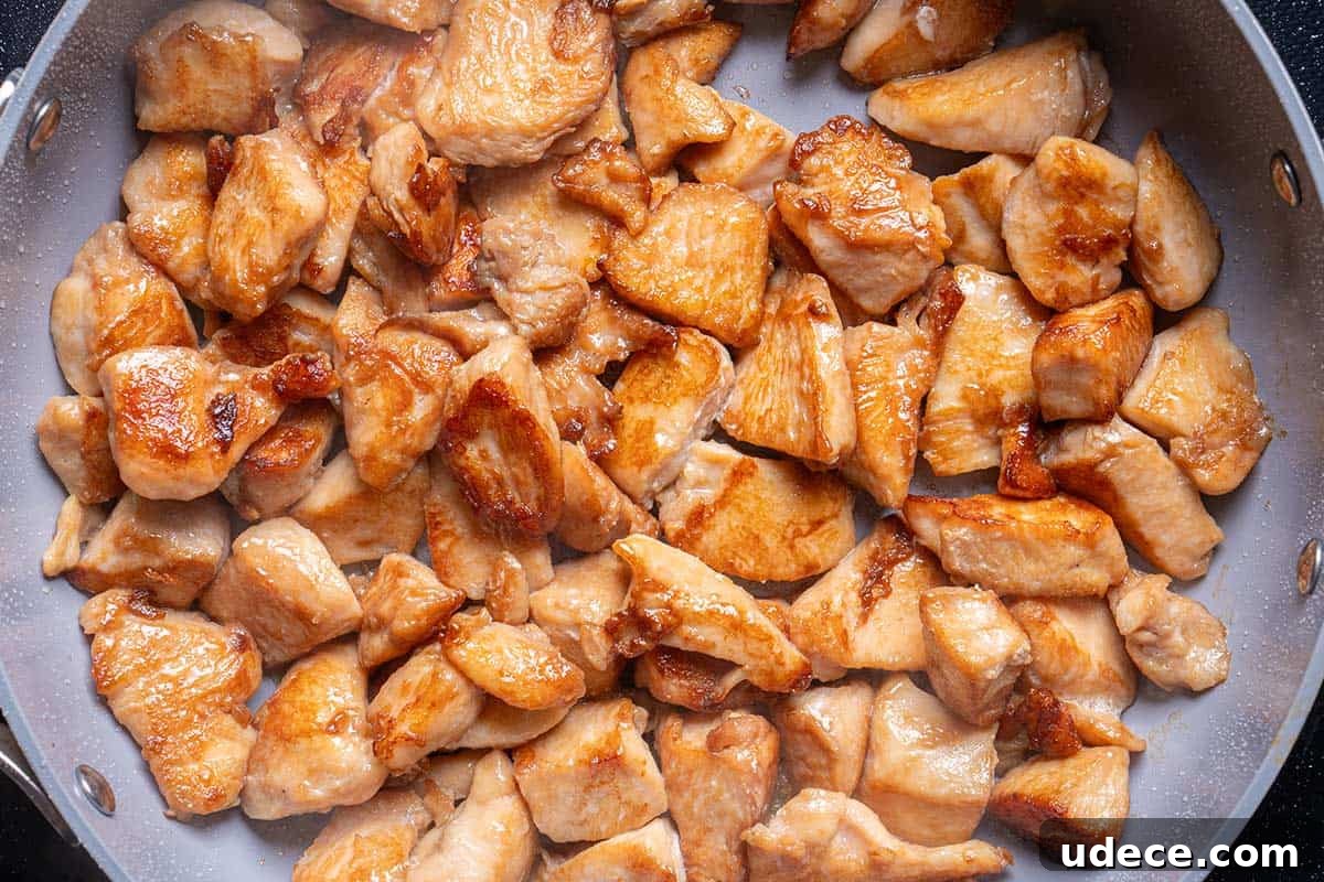 diced chicken seared in a pan