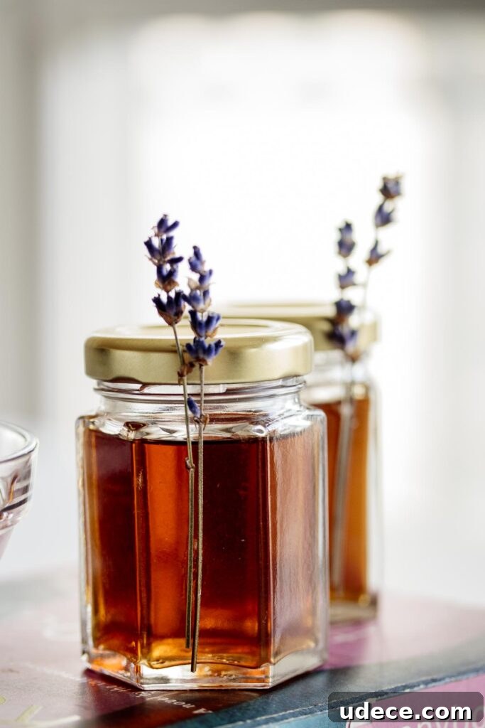 Homemade Lavender Extract for Baking and Cocktails 8 A jar of lavender extract with lavender flowers.