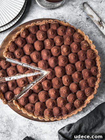 Two slices are cut out of a chocolate tart