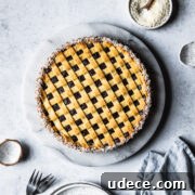 A baked pasta frola (quince tart) with thin lattice on top and a border of dessicated coconut.