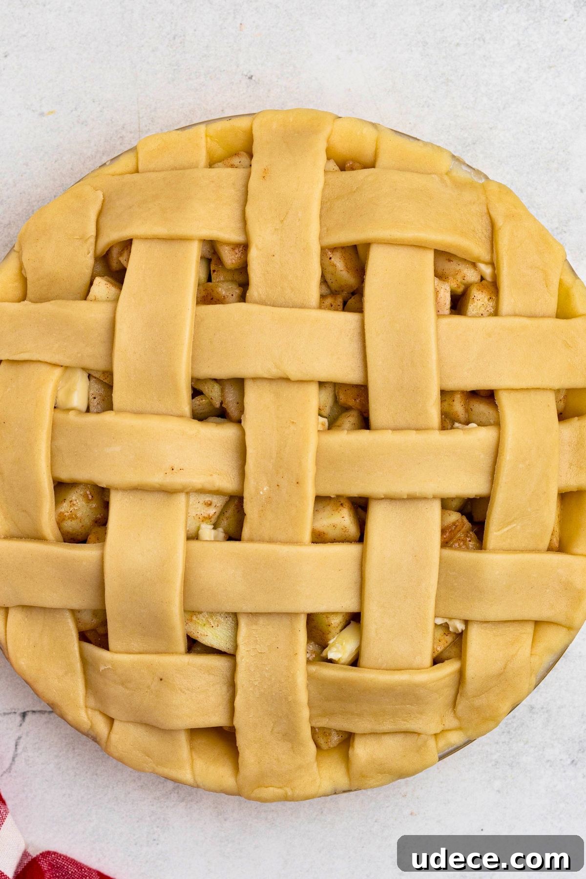 Classic Homemade Apple Pie Recipe for Perfect Crust and Filling 7 Unbaked apple pie with criss cross lattice crust on top.