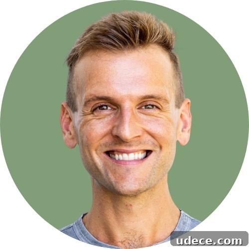 Kaleb Wyse headshot standing in front of light green background.