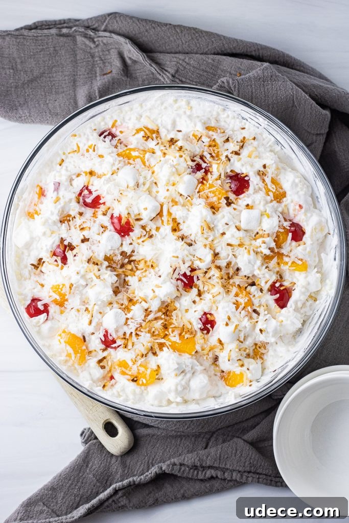 Refreshing Frog Eye Salad Recipe with Pineapple & Whipped Cream 2 fluffy fruit salad with small pasta, oranges, cherries and topped with toasted coconut