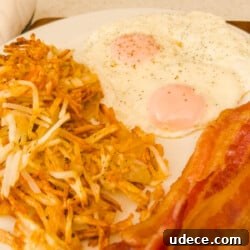 Crispy Air Fryer Hash Browns Ready in 15 Minutes 7 Close up of bacon eggs and hash browns on a plate