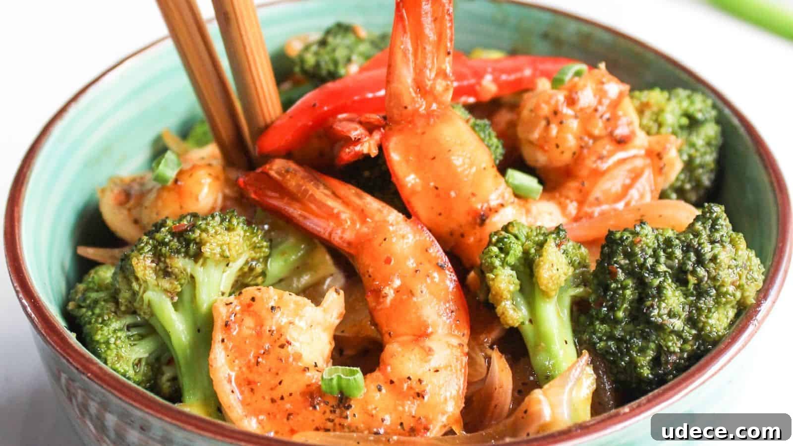 28 Seafood Dinners for Two That Deliver Restaurant-Quality Flavor 8 Bowl of stir-fried shrimp and broccoli with chopsticks.