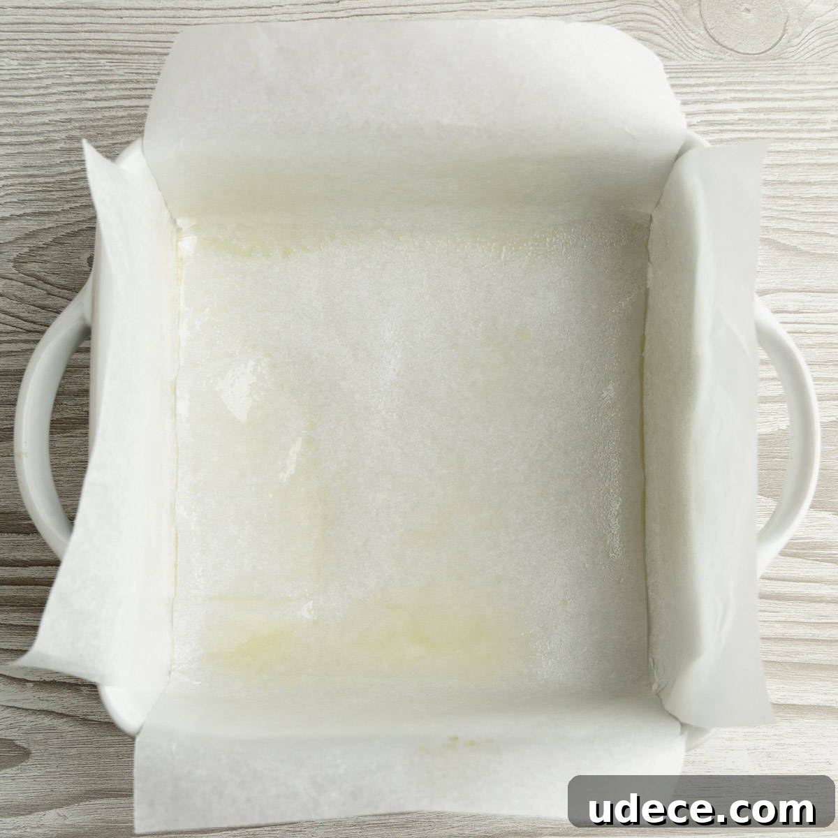 Graveyard Brownies: Spooky Halloween Dessert Recipe 3 A square baking dish lined with parchment paper.