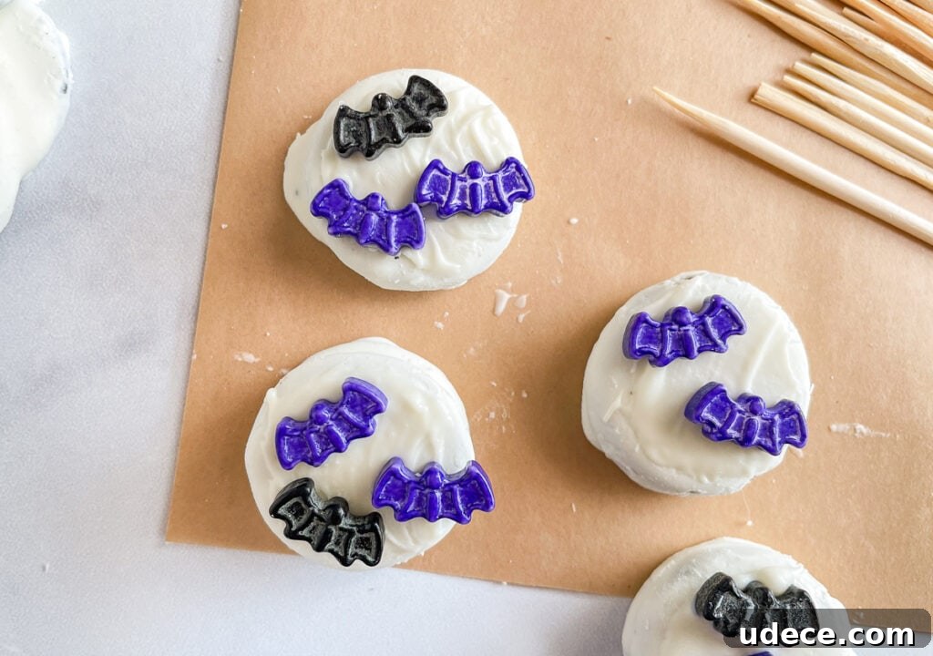 Graveyard Brownies: Spooky Halloween Dessert Recipe 6 Attaching the bat sprinkles to the melted candy coating