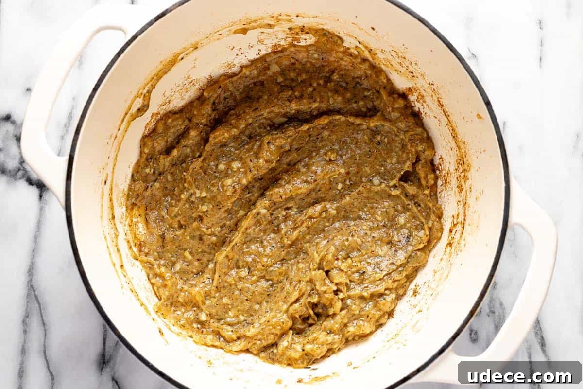Golden brown roux with sauteed veggies in a large pot. 