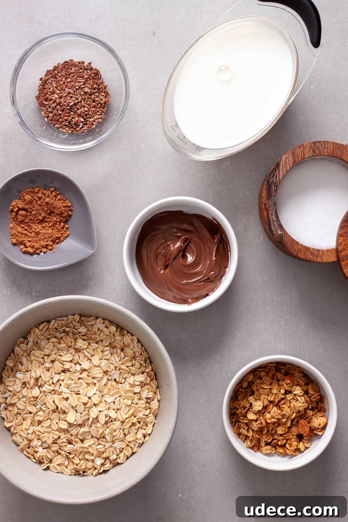 Nutella Overnight Oats Recipe for Creamy Chocolate Breakfast 3 Ingredients for nutella overnight oats on a gray table.