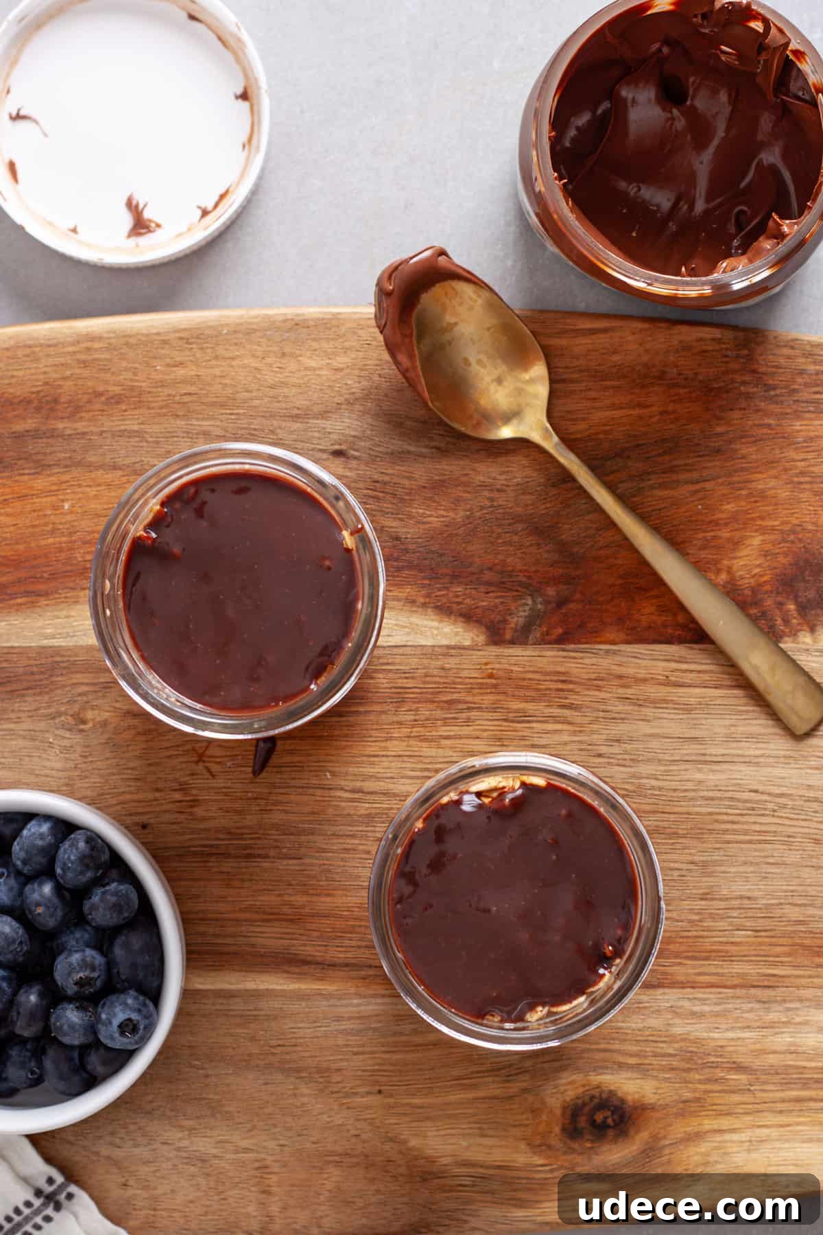 Nutella Overnight Oats Recipe for Creamy Chocolate Breakfast 8 Small mason jars with overnight oats topped with nutella.