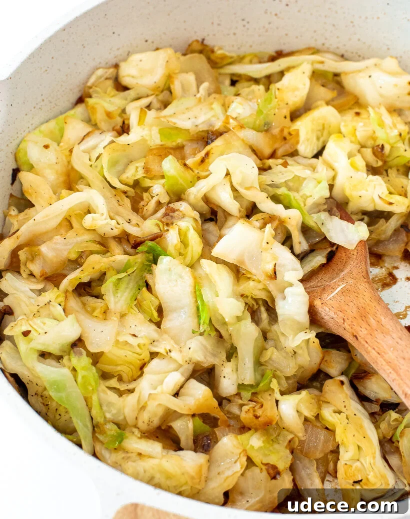 Garlic Butter Sautéed Cabbage Recipe for Quick Weeknight Sides 7 Cabbage and onions in a skillet after being sautéed.