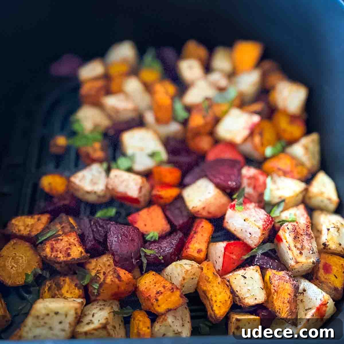The crispy root vegetables in the air fryer basket.