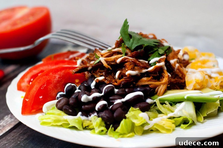 Delicious Slow Cooker BBQ Chicken Taco Salad with black beans and tomatoes.