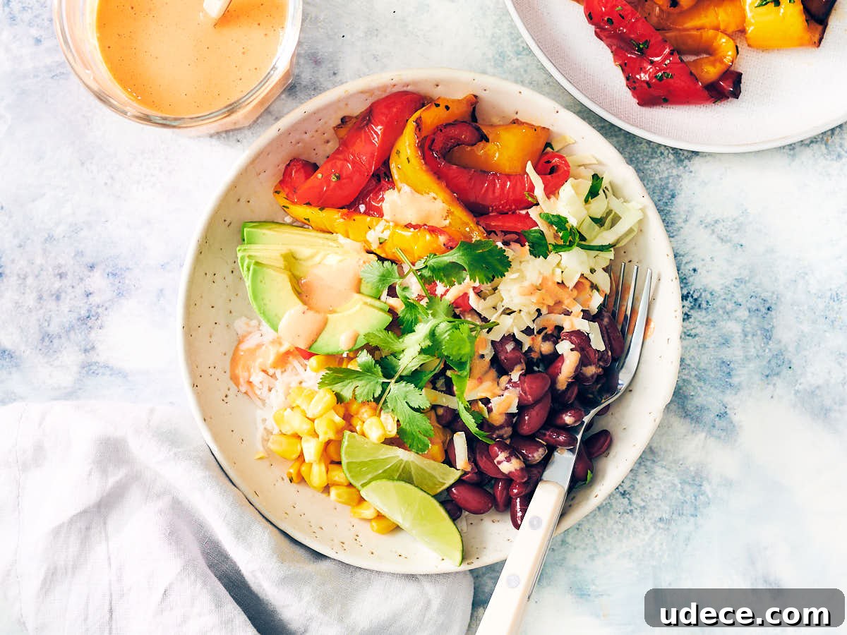 Smoky Roasted Red Pepper Crema Recipe 3 Burrito Bowl with Air Fryer Bell Peppers drizzled with Red Pepper Crema.
