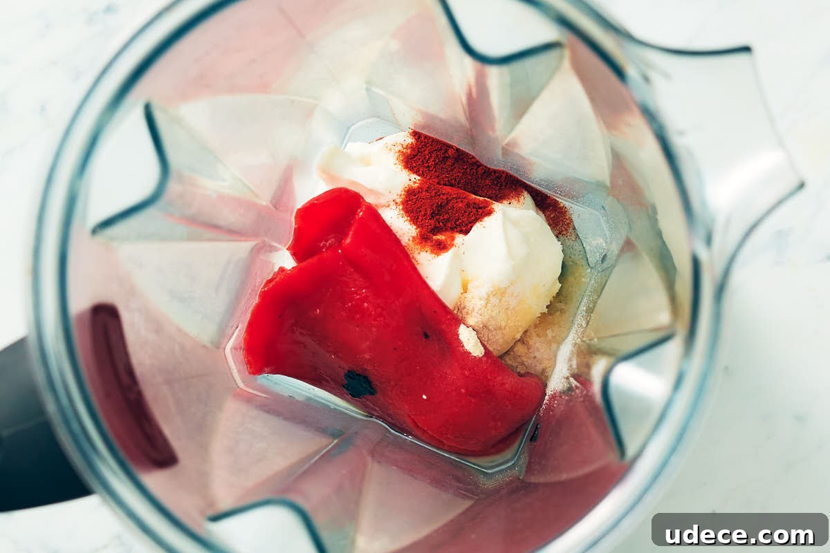 Smoky Roasted Red Pepper Crema Recipe 7 Sour cream, roasted red pepper, lime juice, and spices in a blender container.