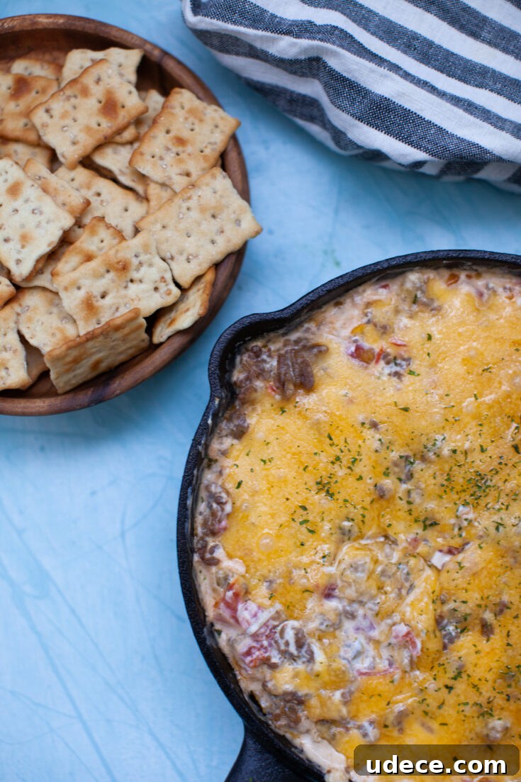 Creamy Skillet Sausage Dip Recipe for Game Day and Parties 4 a bowl of crackers with skillet sausage dip