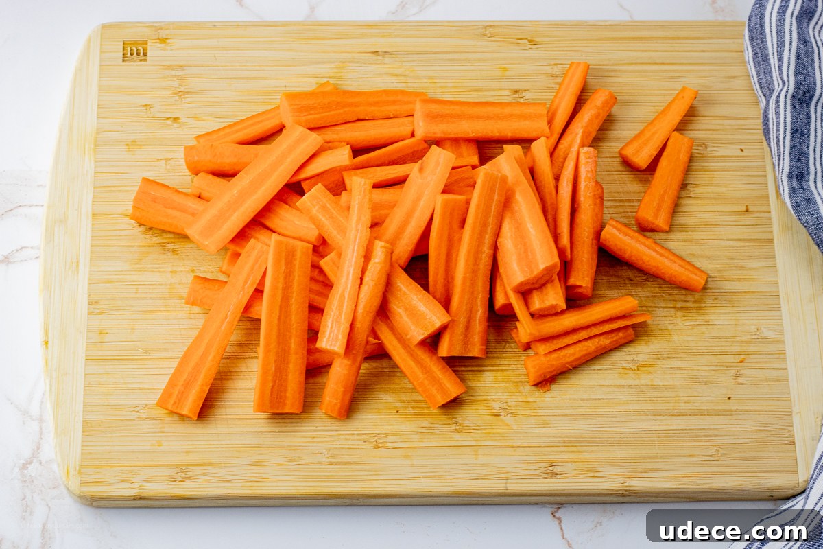 sliced, orange carrots on a wooden cutting board