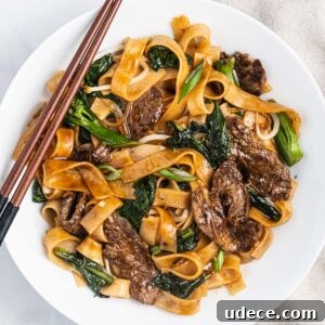 Vietnamese Stir-Fried Hủ Tiếu Noodles with Beef Recipe 12 A plate of flat wide noodles (hu tieu) with beef and Chinese broccoli (gai lan).
