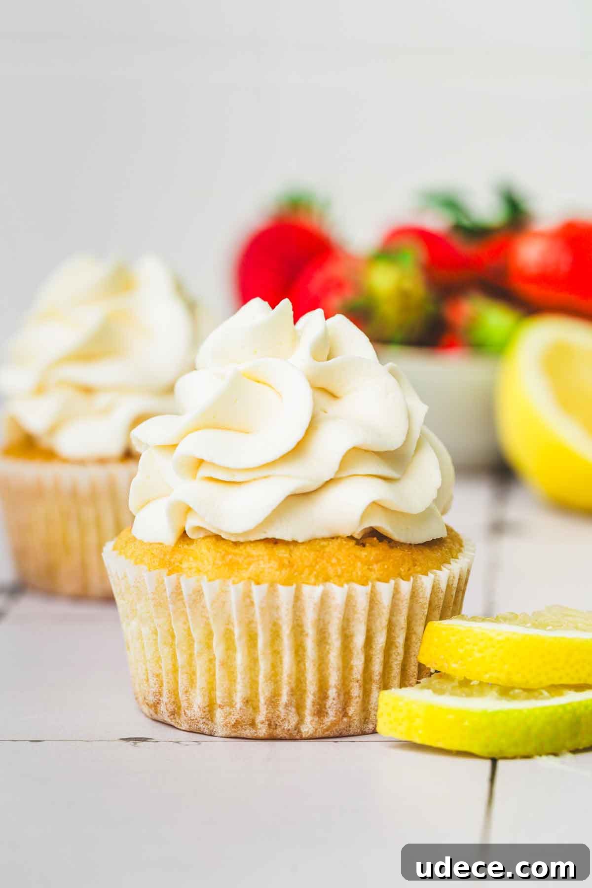 Tangy Lemon Cream Cheese Frosting Recipe for Cakes & Cupcakes 2 cupcakes topped with lemon cream cheese frosting