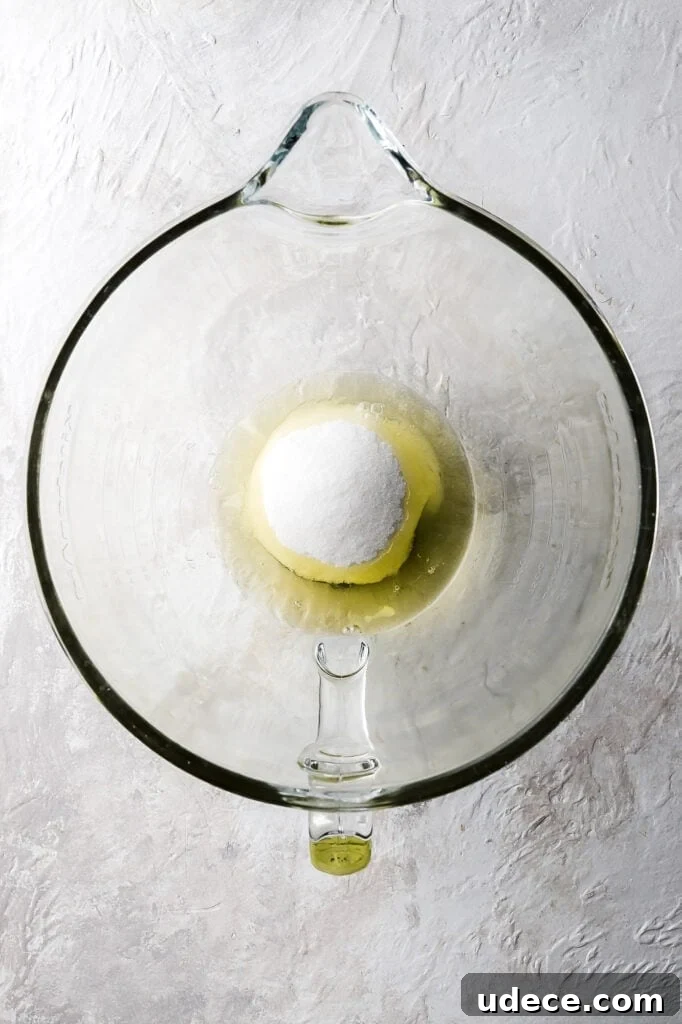 raw egg whites and sugar in the bowl of a stand mixer