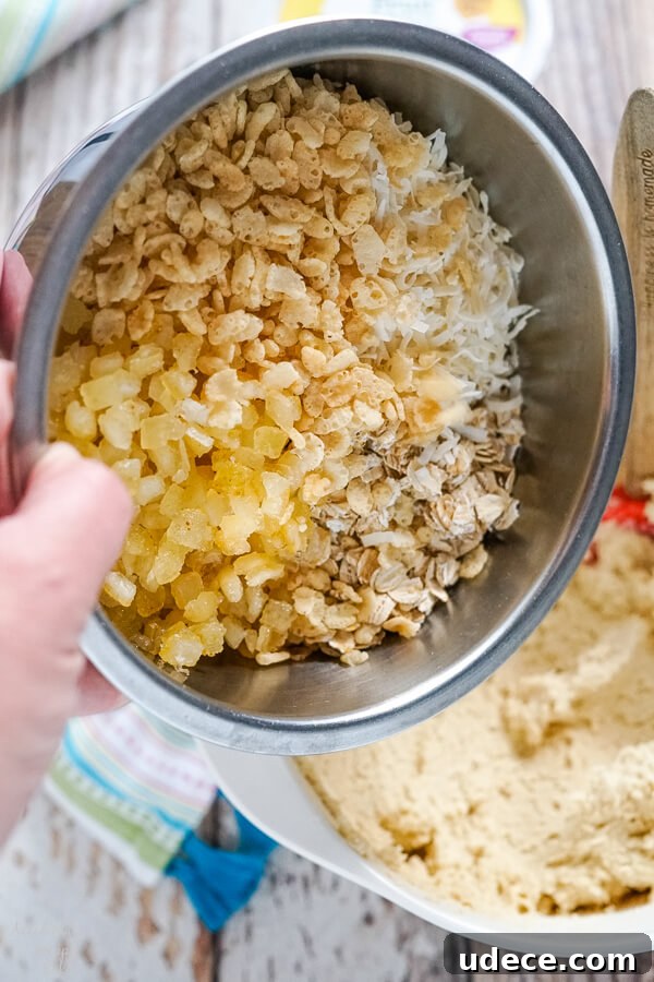 Zesty Lemon Cowboy Cookies Recipe for Soft, Chewy Treats 4 Adding the candied lemon peel, oats, coconut, and rice crispies to the cookie dough.