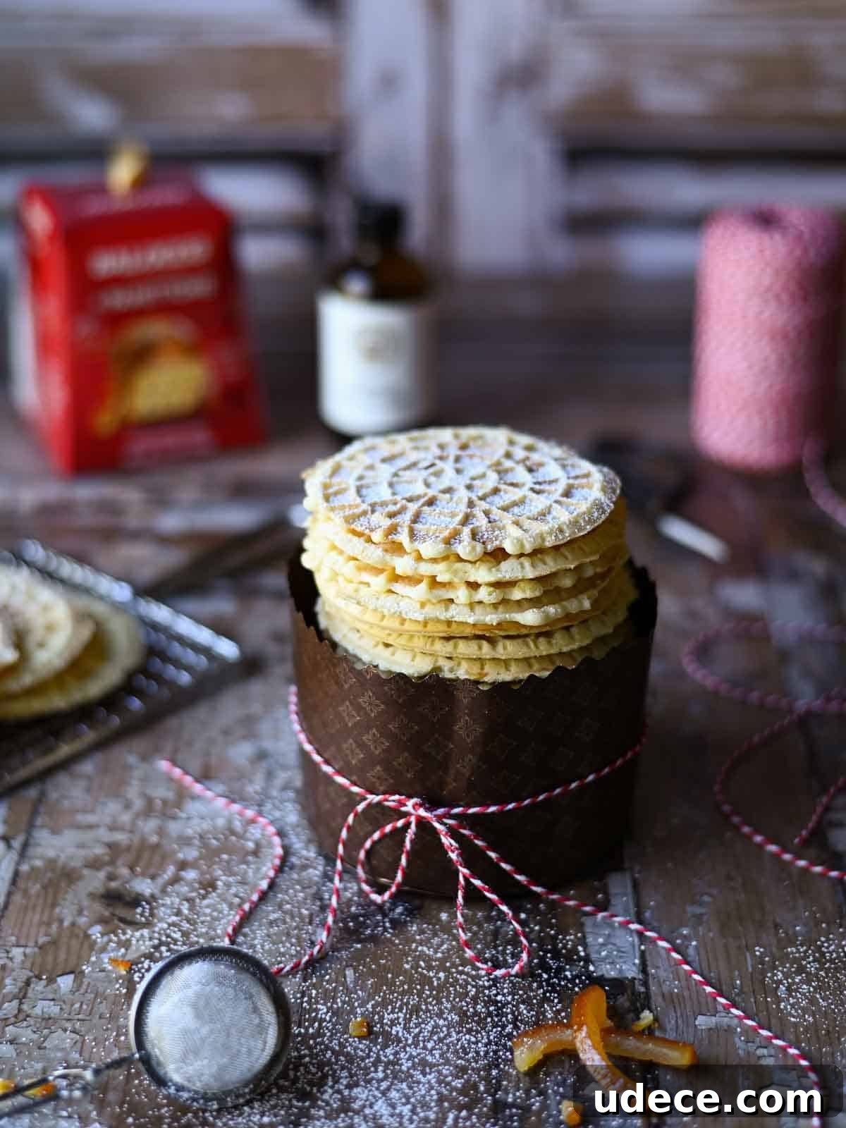 Panettone Pizzelle: Italian Festive Cookies Made from Panettone 2 Angled view of panettone pizzelle in a wrapper with bakers string around it.