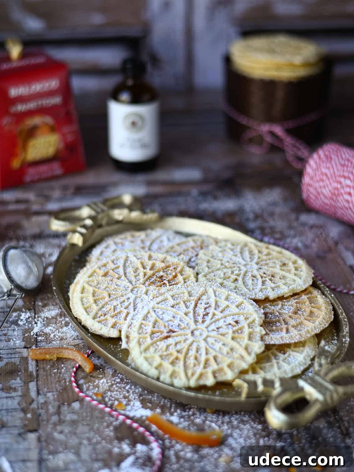 Panettone Pizzelle: Italian Festive Cookies Made from Panettone 5 Pizzelle on an oval platter on a wood surface.