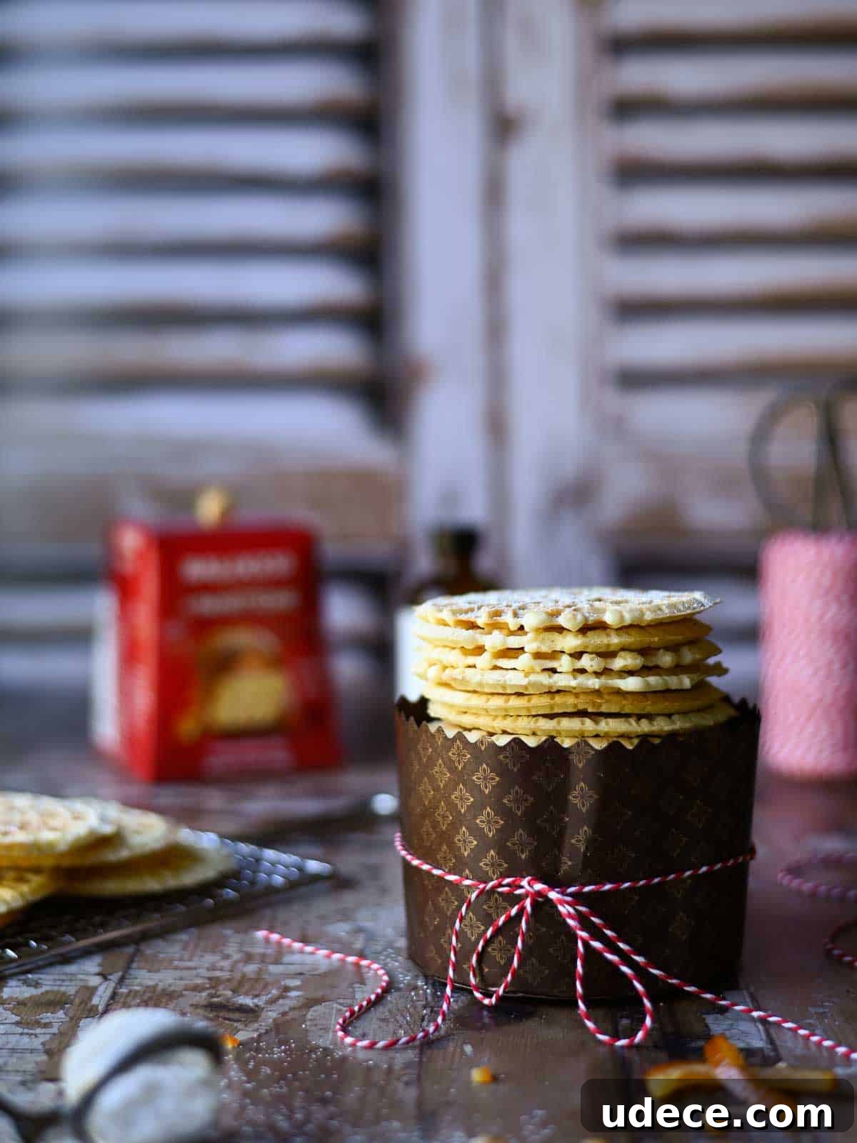 Panettone Pizzelle: Italian Festive Cookies Made from Panettone 6 Eye level view of pizzelle in a panettone wrapper.