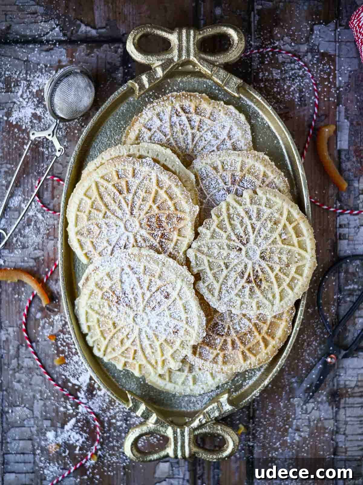 Panettone Pizzelle: Italian Festive Cookies Made from Panettone 7 Overhead of pizzelle cookies on an oval plate with bows.