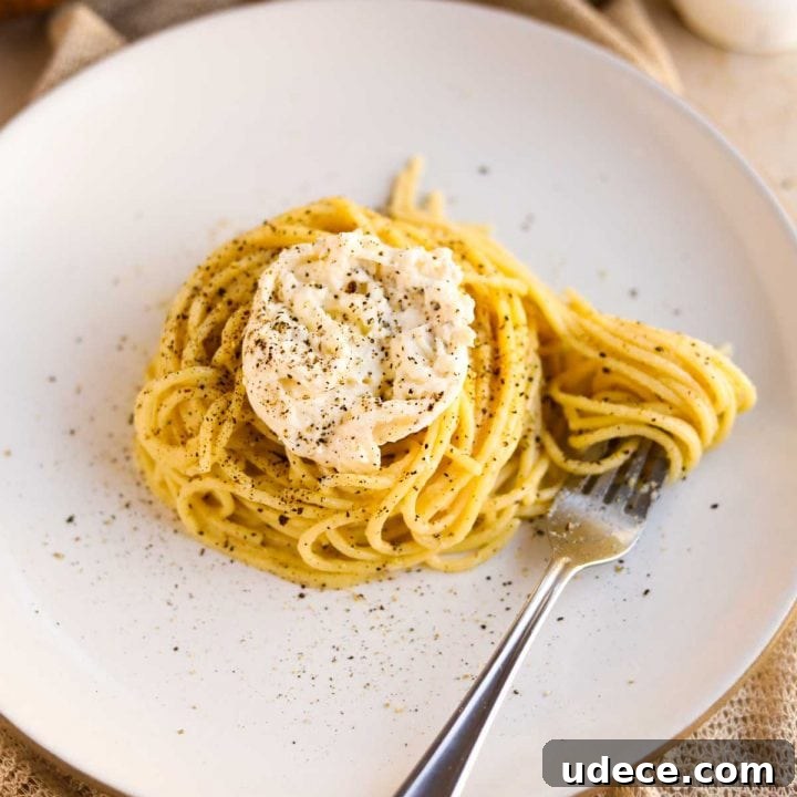 Cacio e pepe with Burrata on a white heath ceramics plate.