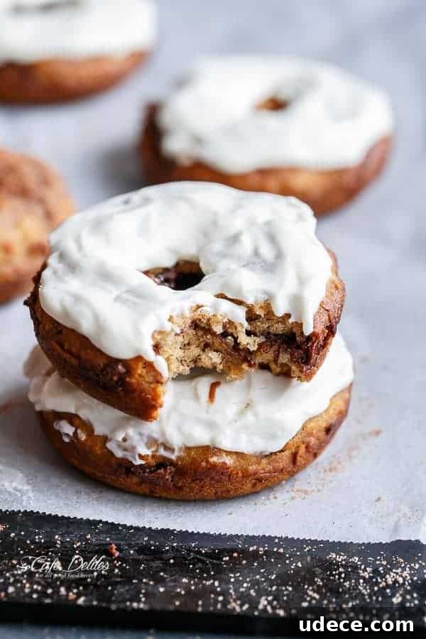 Baked Banana Donuts Recipe — Moist Homemade Banana Bread Donuts 12 cream cheese topped of donuts with a bite taken out