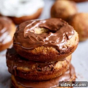 Baked Banana Donuts Recipe — Moist Homemade Banana Bread Donuts 13 Nutella Stuffed Baked Banana Bread Donuts with Cream Cheese Frosting being stack on each other