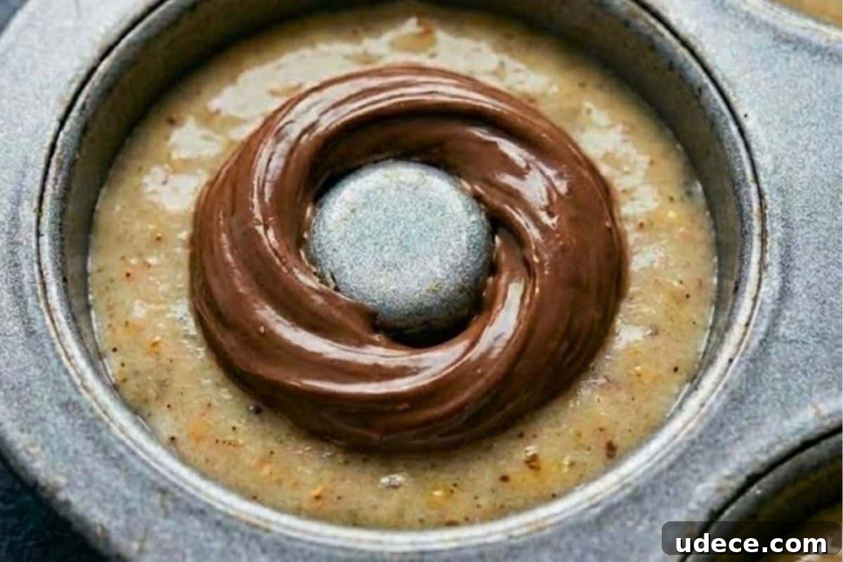 Baked Banana Donuts Recipe — Moist Homemade Banana Bread Donuts 7 Spoon batter into the pans until halfway full. Spoon 1 teaspoon of Nutella over the batter, then carefully cover with more batter to seal