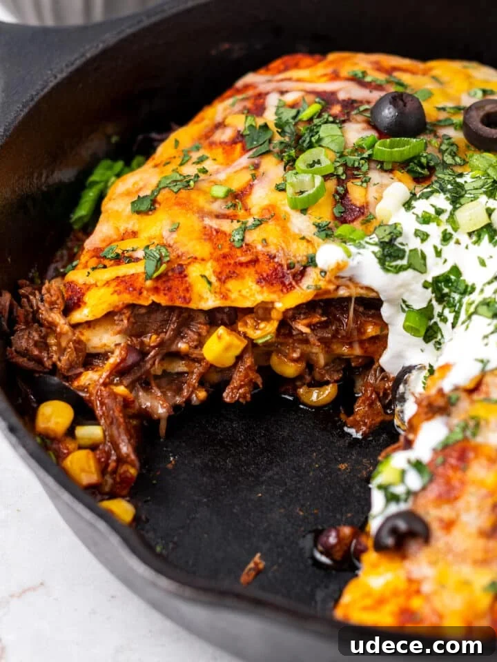 Cheesy Beef Enchilada Pie Recipe for Dinner Crowd-Pleasers 14 inside view of enchilada bake featuring shredded beef, cheese and corn