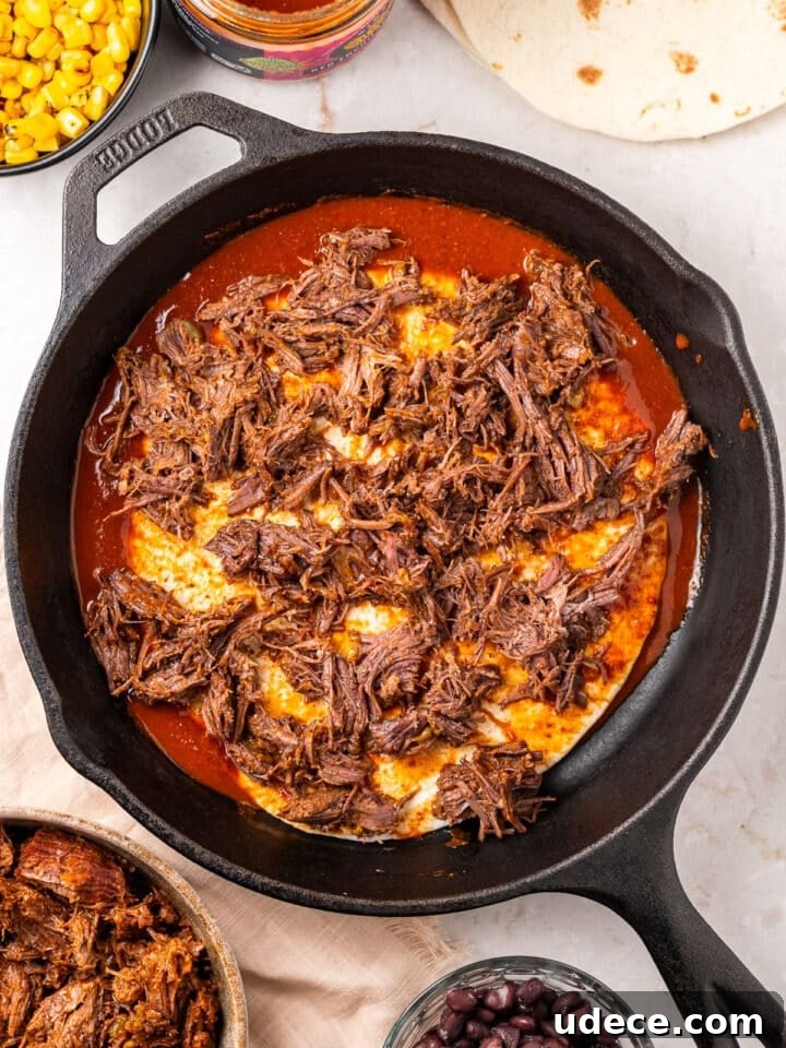 Cheesy Beef Enchilada Pie Recipe for Dinner Crowd-Pleasers 6 shredded beef on the tortilla in the skillet