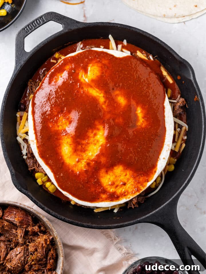 Cheesy Beef Enchilada Pie Recipe for Dinner Crowd-Pleasers 10 final layer of tortilla and enchilada sauce on skillet