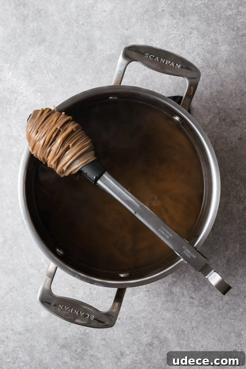 Cooked soba noodles in a saucepan.