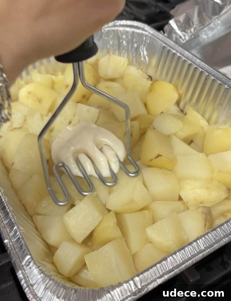Silky Oven-Baked Mashed Potatoes with Creamy Texture 4 mashing mashed potatoes with a masher