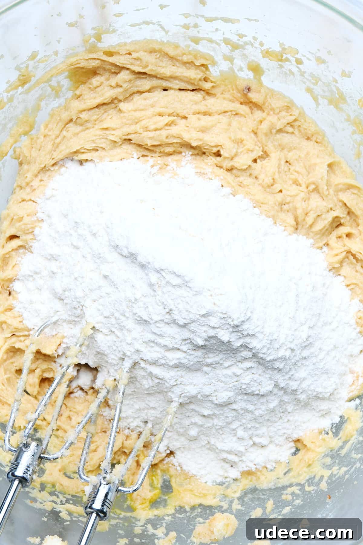 Dry ingredients are combined with the blended wet ingredients for chocolate chip cookie cake.