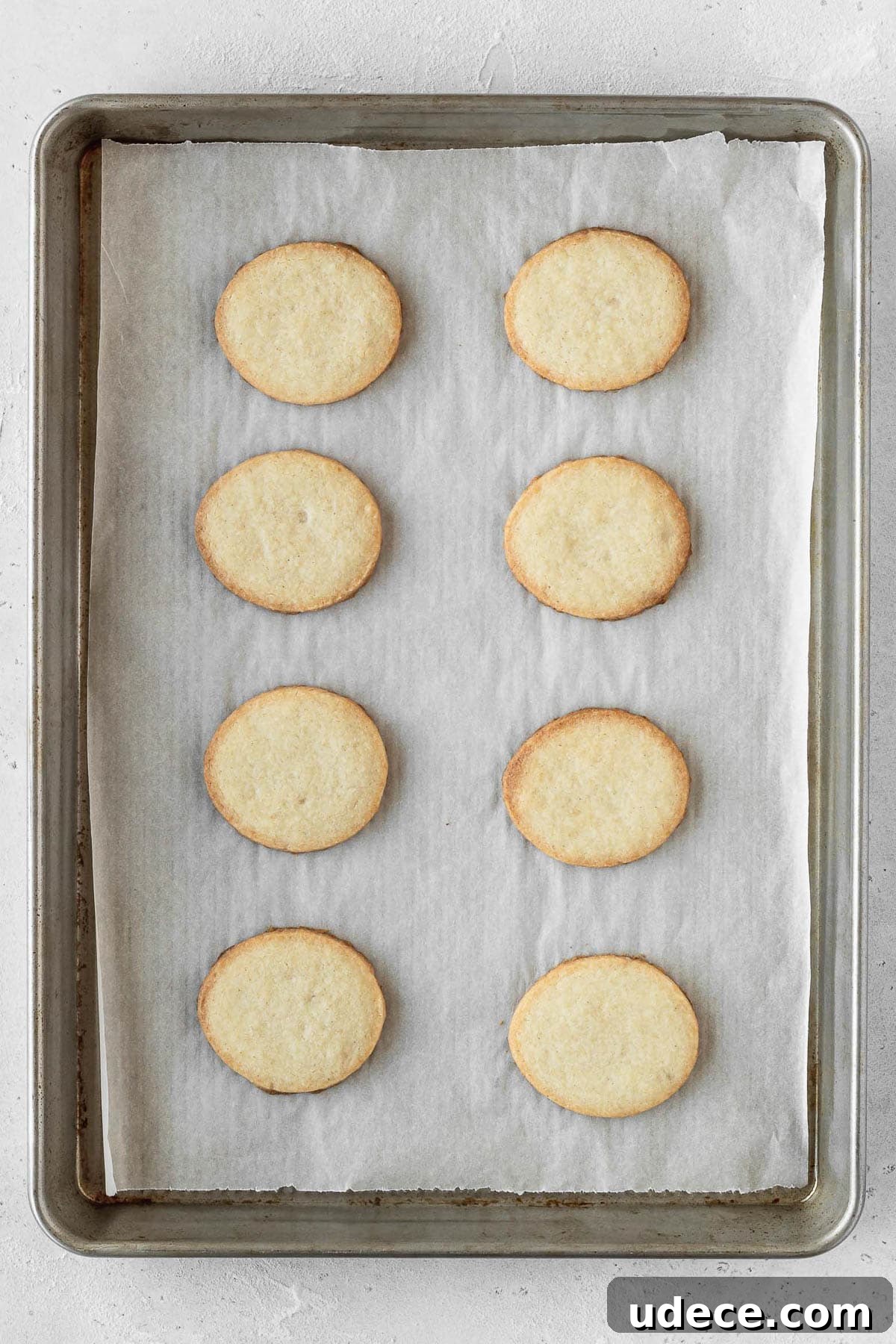 Egg shaped cookies on a baking sheet after they finished baking.