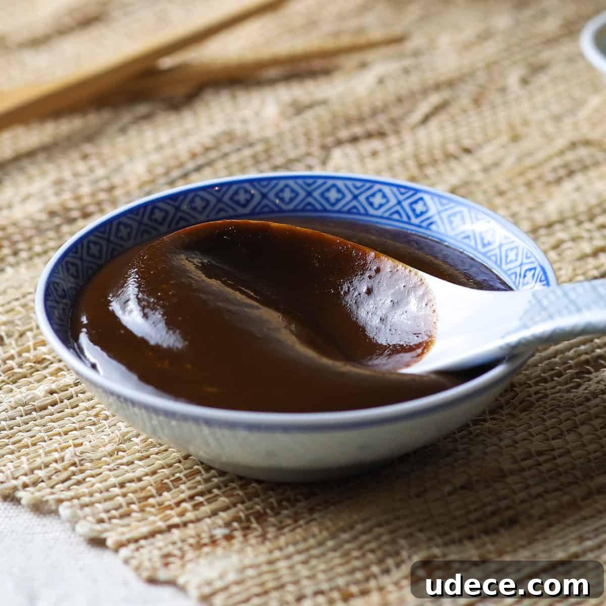 Close-up photo of a shallow Chinese bowl filled with homemade hoisin sauce.