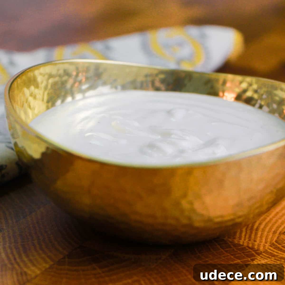 photo of a small brass bowl filled with cashew cream.