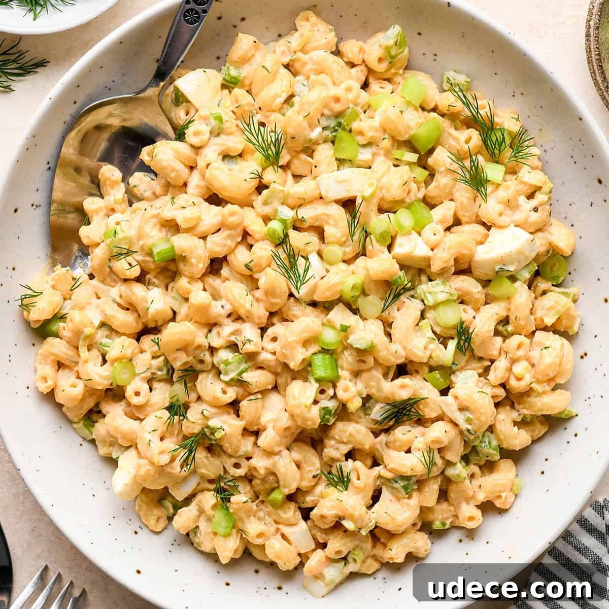 Classic Creamy Macaroni Salad Recipe 2 a bowl of Macaroni Salad garnished with dill and green onions